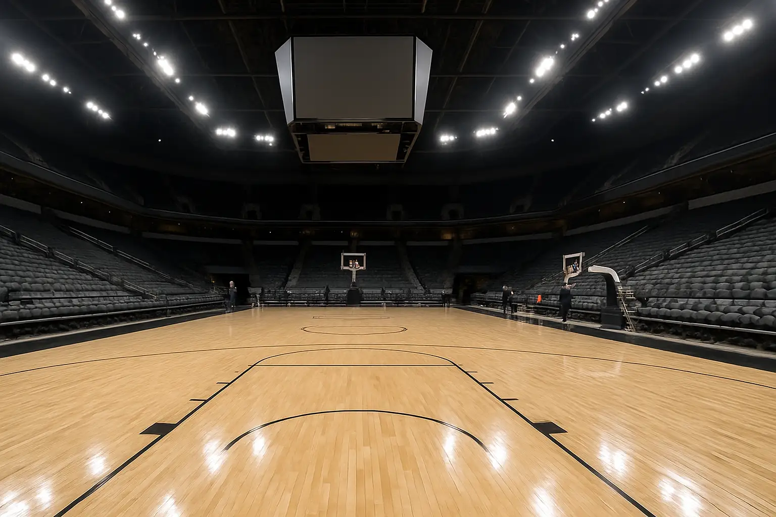 Interior view of a college basketball arena being prepared for the upcoming season