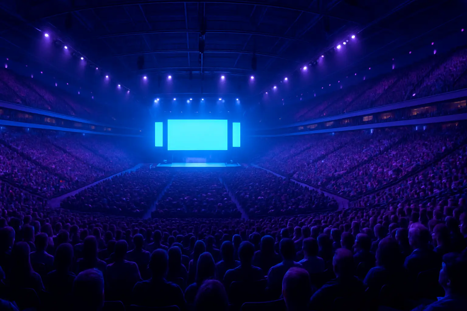 A large esports arena filled with fans watching a competitive gaming event on giant screens
